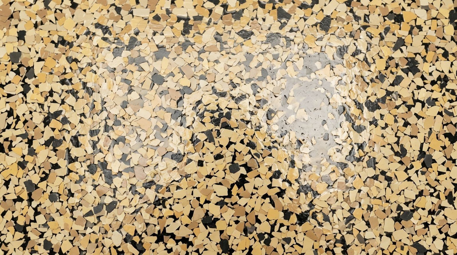 Close-up of a cream, yellow and charcoal decorative flake floor