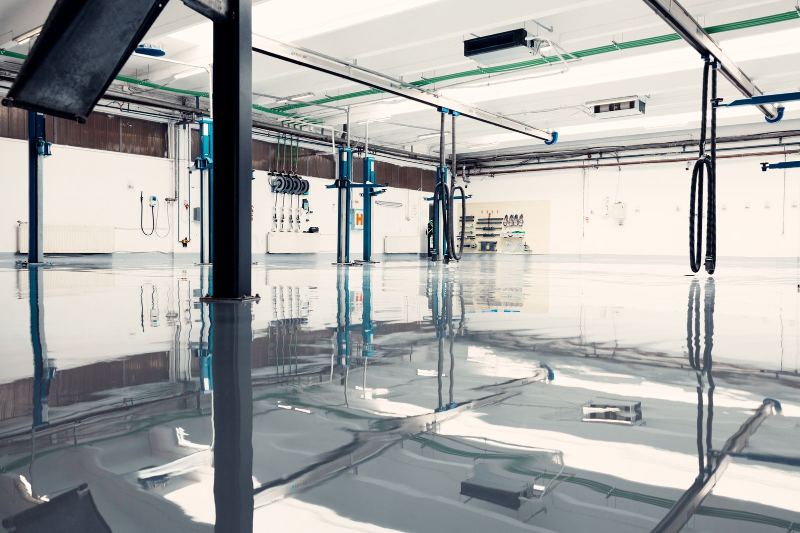 Reflective high-gloss shop floor with car lifts
